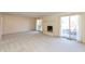 Spacious living room featuring a fireplace, neutral carpet, and sliding glass doors at 7260 Marla Dr, Indianapolis, IN 46256