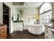 Bright bathroom features a soaking tub under an arched window and a separate vanity area at 8037 Lynch Ln, Indianapolis, IN 46250