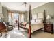 Bright bedroom featuring a four-poster bed with an abundance of natural light from the window at 8037 Lynch Ln, Indianapolis, IN 46250