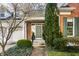 Inviting front entrance with a classic green door, surrounded by lush landscaping and a brick walkway at 8037 Lynch Ln, Indianapolis, IN 46250