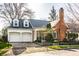 Inviting brick home with a well-manicured lawn, attached garage, and charming curb appeal at 8037 Lynch Ln, Indianapolis, IN 46250