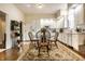 Open kitchen with dining area, white cabinets, stainless appliances, and a brick fireplace at 8037 Lynch Ln, Indianapolis, IN 46250