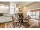 Eat-in kitchen features white cabinets, a glass table, white marble countertops, and stainless appliances at 8037 Lynch Ln, Indianapolis, IN 46250
