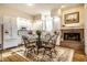Bright kitchen features white cabinets, stainless appliances, fireplace, and hardwood floors at 8037 Lynch Ln, Indianapolis, IN 46250