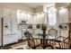 Updated kitchen featuring white cabinets, marble countertops, stainless appliances, and glass table at 8037 Lynch Ln, Indianapolis, IN 46250