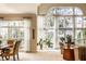 Expansive living room with abundant natural light, plush carpet, and a view of the dining area at 8037 Lynch Ln, Indianapolis, IN 46250