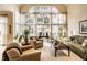 Bright living room with large windows, neutral decor, comfortable seating, and hardwood furniture at 8037 Lynch Ln, Indianapolis, IN 46250