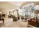 Spacious living room with ample natural light, a dining area, neutral carpet, and comfortable furnishings at 8037 Lynch Ln, Indianapolis, IN 46250