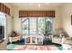 Cozy sunroom with large windows, wicker furniture, striped valances, and tile flooring at 8037 Lynch Ln, Indianapolis, IN 46250