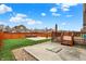 Fenced backyard featuring a wooden deck, basketball court, and well-maintained lawn, perfect for outdoor activities at 8734 Blue Marlin Dr, Indianapolis, IN 46239
