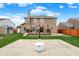 Spacious fenced backyard with a basketball court, deck, and lush green lawn, ideal for outdoor recreation and entertainment at 8734 Blue Marlin Dr, Indianapolis, IN 46239