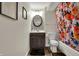 Updated bathroom featuring a modern vanity, decorative mirror, and a colorful shower curtain at 8734 Blue Marlin Dr, Indianapolis, IN 46239