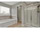 Bathroom with a soaking tub and glass enclosed shower at 8734 Blue Marlin Dr, Indianapolis, IN 46239
