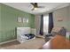A modern bedroom with a crib and comfortable seating, designed for rest and relaxation at 8734 Blue Marlin Dr, Indianapolis, IN 46239