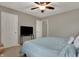 Cozy bedroom featuring a ceiling fan, neutral walls, and a television on a console table at 8734 Blue Marlin Dr, Indianapolis, IN 46239