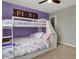 Charming bedroom showcasing a bunk bed with a purple accent wall and wood sign at 8734 Blue Marlin Dr, Indianapolis, IN 46239