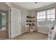 Comfortable bedroom featuring a window, a door, and carpeted floors for added warmth at 8734 Blue Marlin Dr, Indianapolis, IN 46239