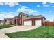 Spacious three-car garage and long driveway, brick accents, and well-kept lawn contribute to curb appeal at 8734 Blue Marlin Dr, Indianapolis, IN 46239