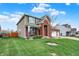 Well-maintained lawn with a charming two-story home, featuring brick accents, a three-car garage, and mature landscaping at 8734 Blue Marlin Dr, Indianapolis, IN 46239