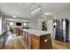 Open concept kitchen with a large island, stainless steel refrigerator, and seamless flow to the living spaces at 8734 Blue Marlin Dr, Indianapolis, IN 46239