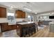 Well-appointed kitchen with an island and seating open to a dining area and access to outdoor deck at 8734 Blue Marlin Dr, Indianapolis, IN 46239