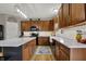 Modern kitchen featuring dark wood cabinets, stainless appliances, and a subway tile backsplash at 8734 Blue Marlin Dr, Indianapolis, IN 46239