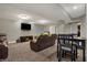 Cozy living room with plush leather sofas, entertainment center, and an adjacent dining area at 8734 Blue Marlin Dr, Indianapolis, IN 46239