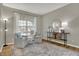 Bright living room featuring hardwood floors, neutral walls, large windows, and stylish decor creates an inviting space at 8734 Blue Marlin Dr, Indianapolis, IN 46239