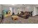 Spacious living room area with reclining leather seating and a play area for children at 8734 Blue Marlin Dr, Indianapolis, IN 46239