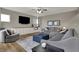 Inviting living room with a large sectional sofa, a ceiling fan and a mounted TV at 8734 Blue Marlin Dr, Indianapolis, IN 46239