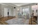 Open living room with hardwood floors, neutral walls, and large windows creating a bright and airy space at 8734 Blue Marlin Dr, Indianapolis, IN 46239