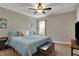 Comfortable main bedroom with a bed, window, wooden bench, and a ceiling fan at 8734 Blue Marlin Dr, Indianapolis, IN 46239