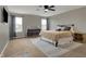 Cozy main bedroom featuring a queen-size bed, two windows, and a ceiling fan at 8734 Blue Marlin Dr, Indianapolis, IN 46239