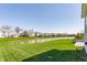 Lush backyard featuring a scenic pond and well-maintained lawn at 8855 Sugar Cay Ct, Zionsville, IN 46077