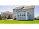Backyard featuring a patio, stairs leading to the upper level, and a charming sunroom with many windows at 8855 Sugar Cay Ct, Zionsville, IN 46077