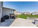 Expansive backyard patio with a grill, a pond, and lush greenery at 8855 Sugar Cay Ct, Zionsville, IN 46077