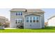 Backyard features a patio, stairs leading to the upper level, and a sunroom at 8855 Sugar Cay Ct, Zionsville, IN 46077