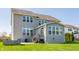 Backyard with a patio, stairs leading to the upper level, and a sunroom with plenty of natural light at 8855 Sugar Cay Ct, Zionsville, IN 46077