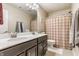 Bathroom with a double vanity, large mirror, and a shower-tub combo at 8855 Sugar Cay Ct, Zionsville, IN 46077