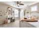 Charming bedroom with a ceiling fan, decorated desk, and natural light from a window at 8855 Sugar Cay Ct, Zionsville, IN 46077