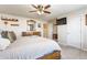 Inviting bedroom featuring a bed, overhead fan, and a dresser with mirror at 8855 Sugar Cay Ct, Zionsville, IN 46077