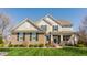 Charming two-story home featuring a brick facade, complemented by a well-manicured lawn and established landscaping at 8855 Sugar Cay Ct, Zionsville, IN 46077