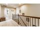 Bright hallway with iron railing, plush carpeting, and recessed lighting at 8855 Sugar Cay Ct, Zionsville, IN 46077