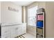 Functional laundry room with white cabinetry, granite countertop, and storage shelves at 8855 Sugar Cay Ct, Zionsville, IN 46077