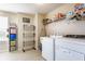 Bright laundry room with modern appliances, ample storage, and natural light at 8855 Sugar Cay Ct, Zionsville, IN 46077