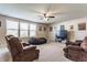 Spacious living area with neutral carpet, a ceiling fan, and plenty of natural light at 8855 Sugar Cay Ct, Zionsville, IN 46077