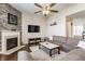 Cozy living room showcasing a stone fireplace, large sectional sofa, and hardwood floors, perfect for entertaining at 8855 Sugar Cay Ct, Zionsville, IN 46077