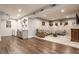 Spacious living area with a wet bar, ample seating and a seamless blend of carpet and wood flooring at 8855 Sugar Cay Ct, Zionsville, IN 46077