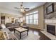 Bright living room boasting a stone fireplace, large windows, and hardwood floors, creating a welcoming atmosphere at 8855 Sugar Cay Ct, Zionsville, IN 46077