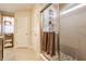 Walk-in shower featuring tile surround, glass door, and convenient shelving at 8855 Sugar Cay Ct, Zionsville, IN 46077